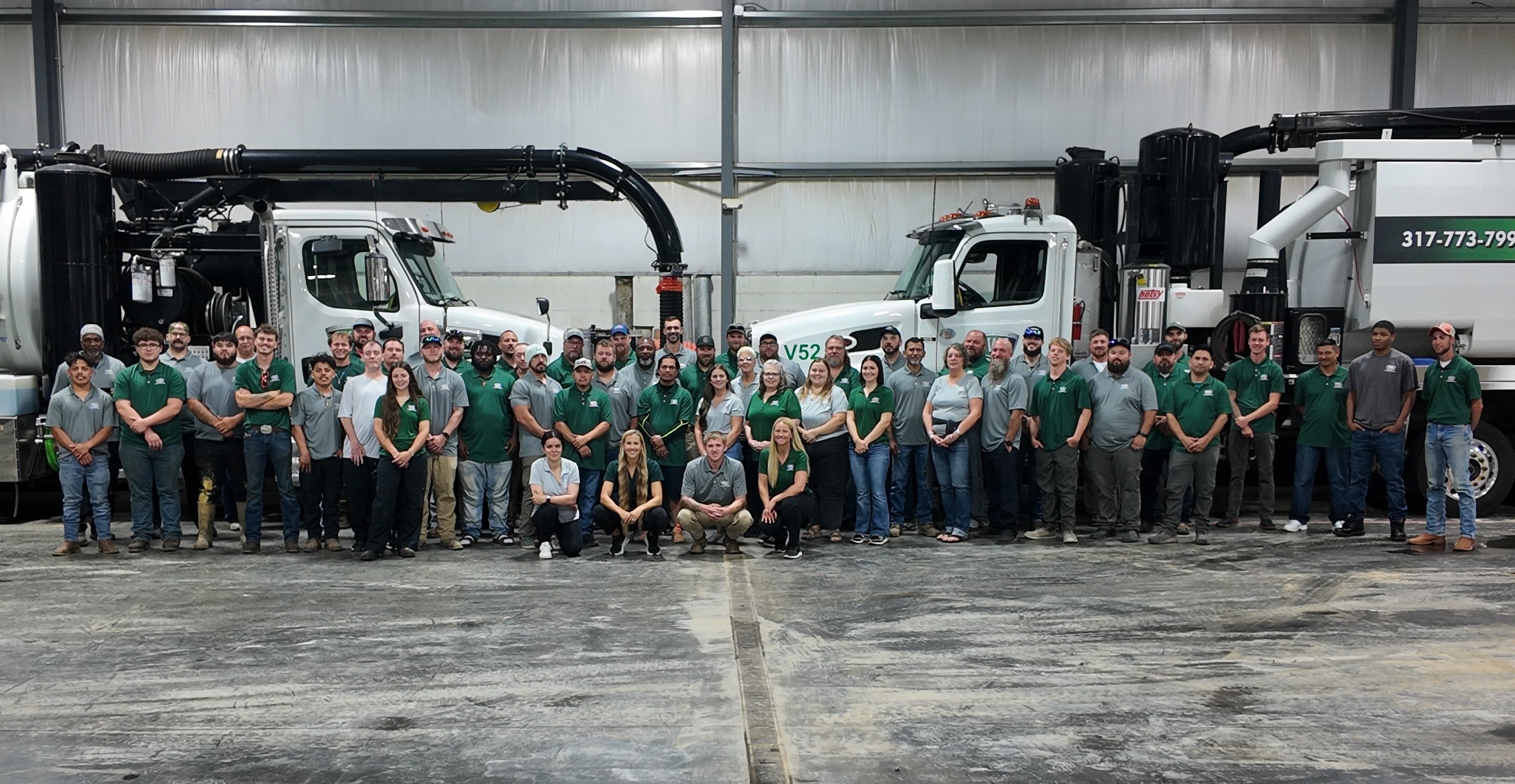 Fluid Waste Services team and employees in front of their trucks